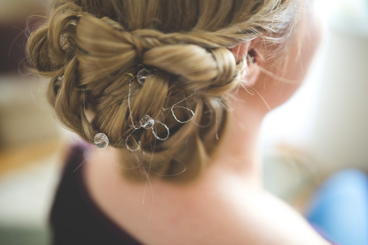 Close-up of an elaborate bridal hairstyle decorated with delicate crystals, perfect for wedding day inspiration.
